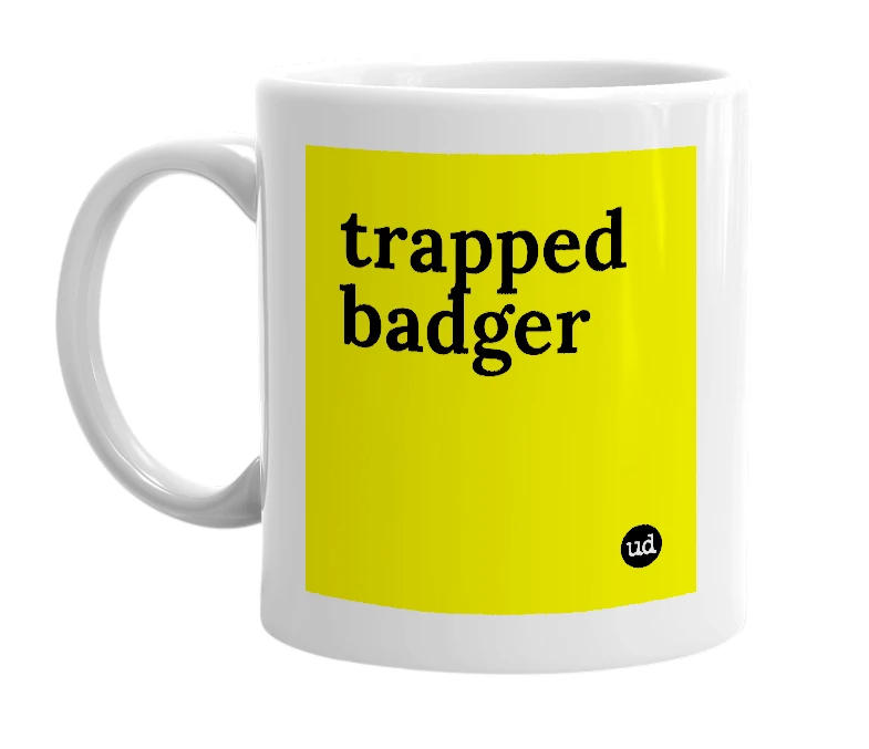 White mug with 'trapped badger' in bold black letters