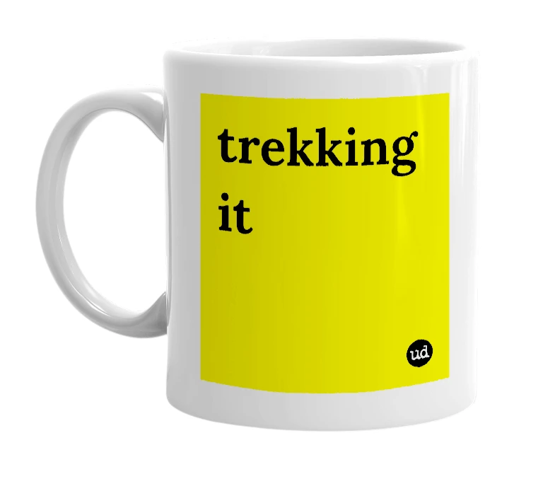 White mug with 'trekking it' in bold black letters