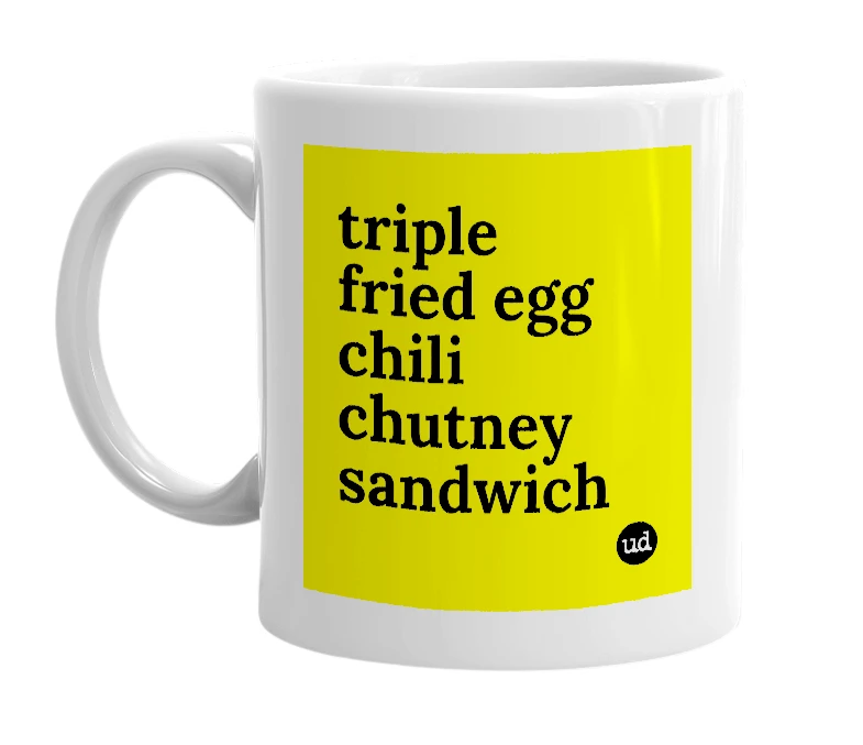 White mug with 'triple fried egg chili chutney sandwich' in bold black letters