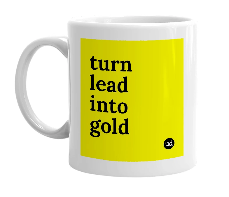 White mug with 'turn lead into gold' in bold black letters