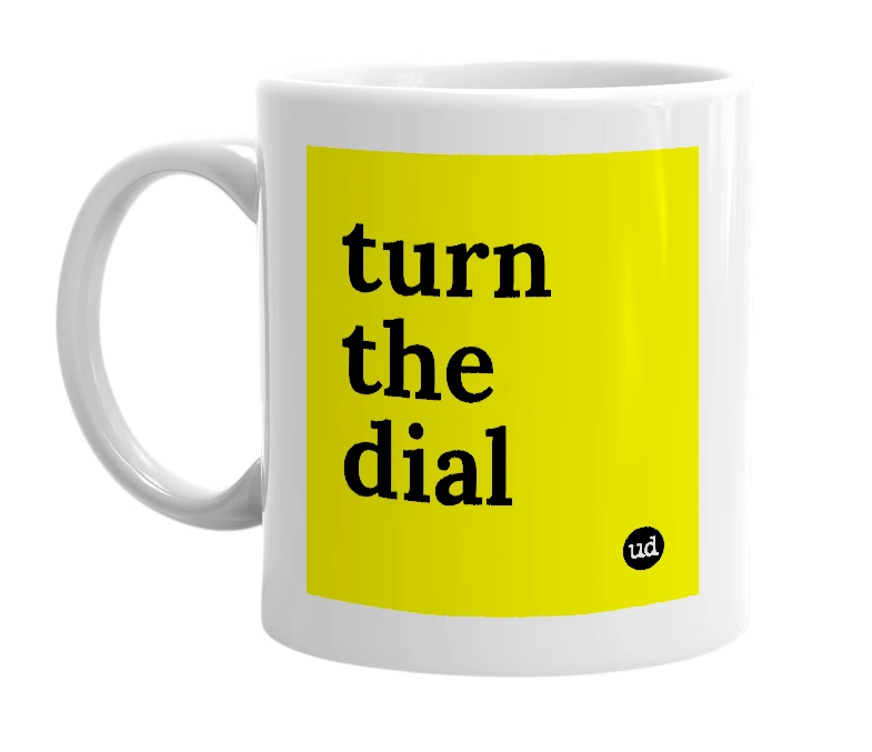 White mug with 'turn the dial' in bold black letters