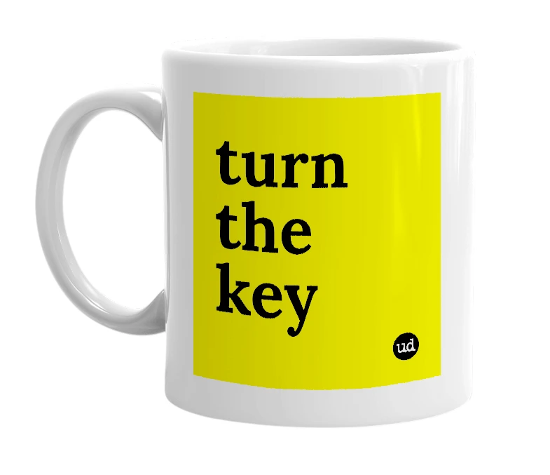 White mug with 'turn the key' in bold black letters