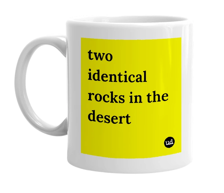 White mug with 'two identical rocks in the desert' in bold black letters