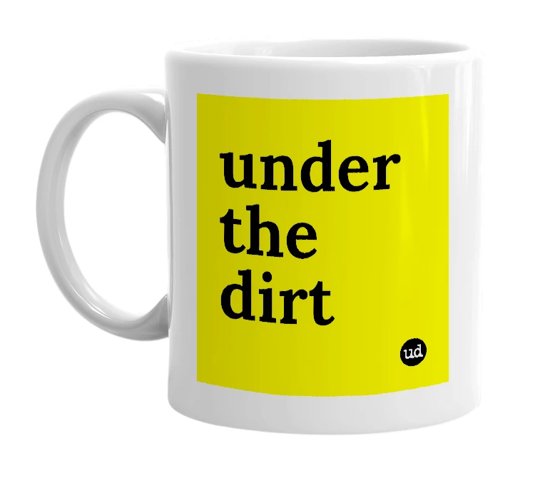 White mug with 'under the dirt' in bold black letters