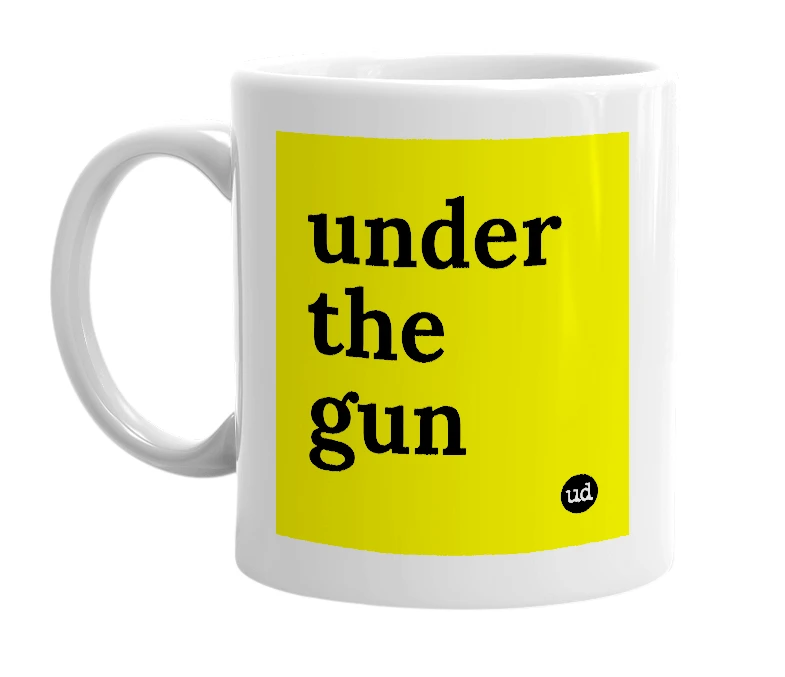 White mug with 'under the gun' in bold black letters