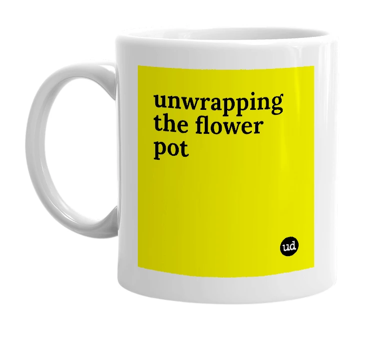 White mug with 'unwrapping the flower pot' in bold black letters
