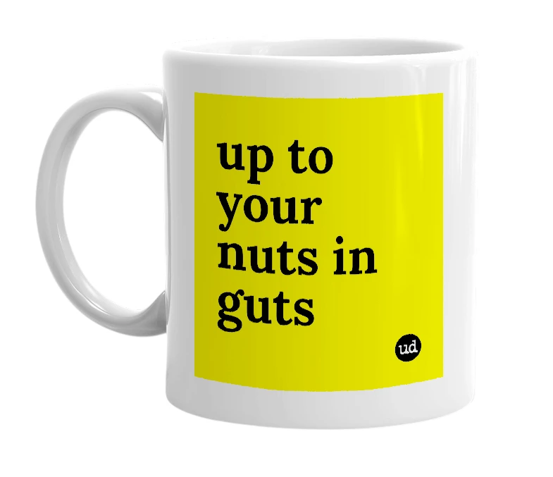 White mug with 'up to your nuts in guts' in bold black letters