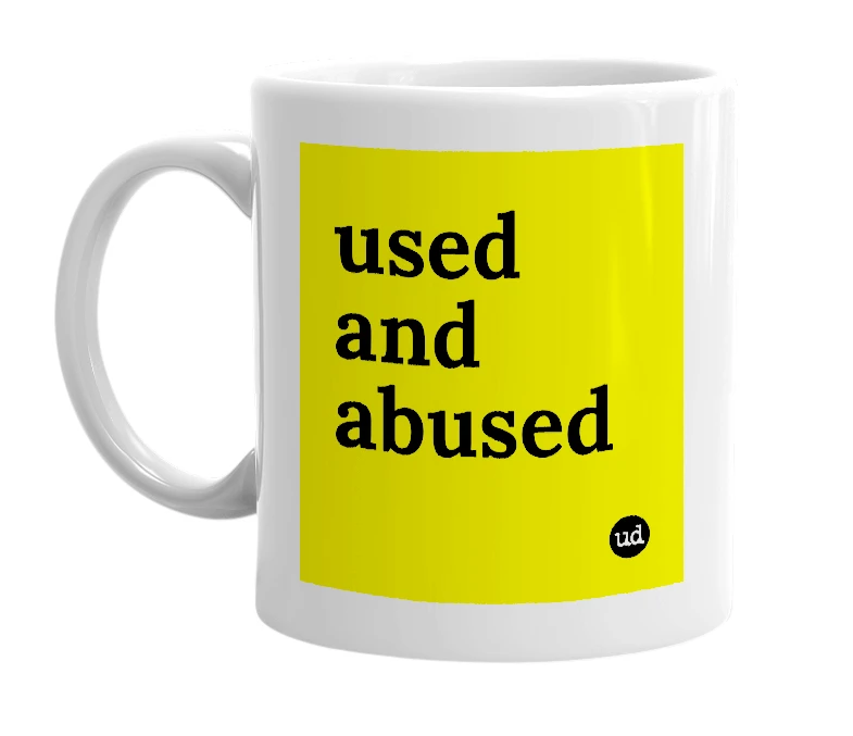 White mug with 'used and abused' in bold black letters
