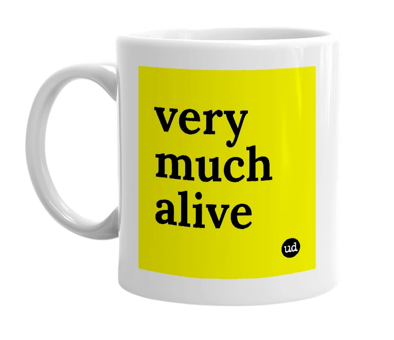White mug with 'very much alive' in bold black letters