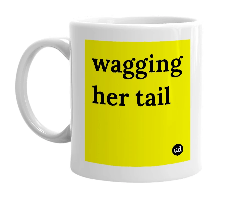 White mug with 'wagging her tail' in bold black letters