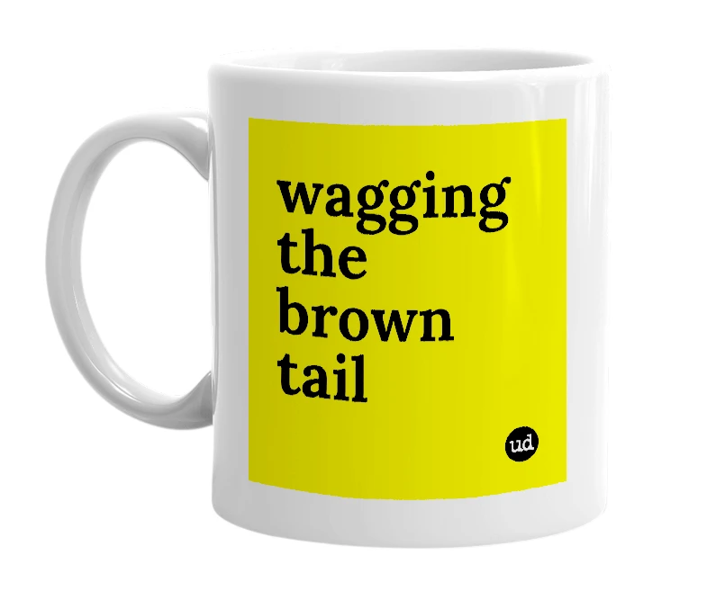 White mug with 'wagging the brown tail' in bold black letters