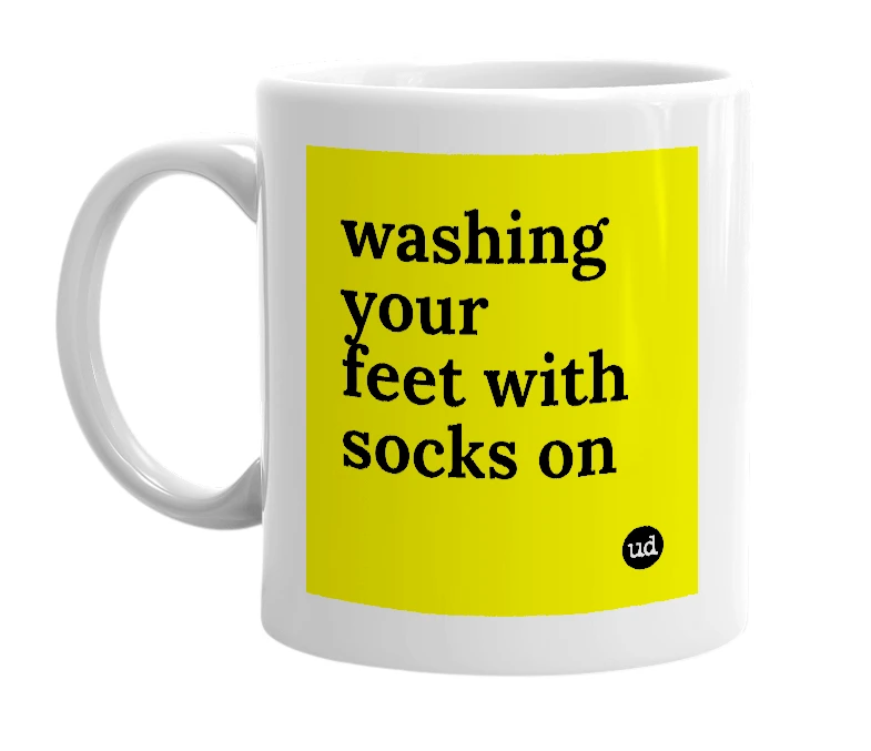 White mug with 'washing your feet with socks on' in bold black letters
