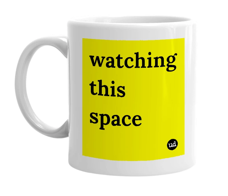 White mug with 'watching this space' in bold black letters