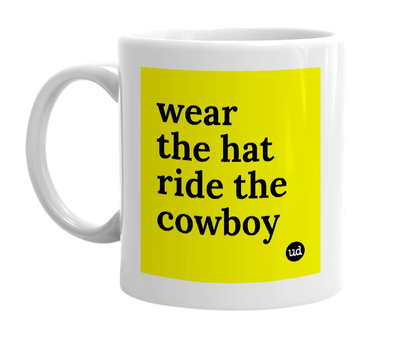 White mug with 'wear the hat ride the cowboy' in bold black letters