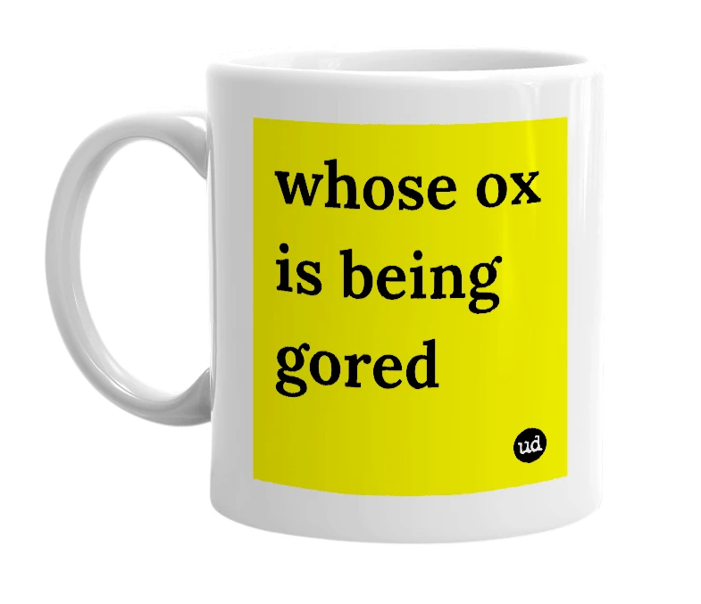 White mug with 'whose ox is being gored' in bold black letters
