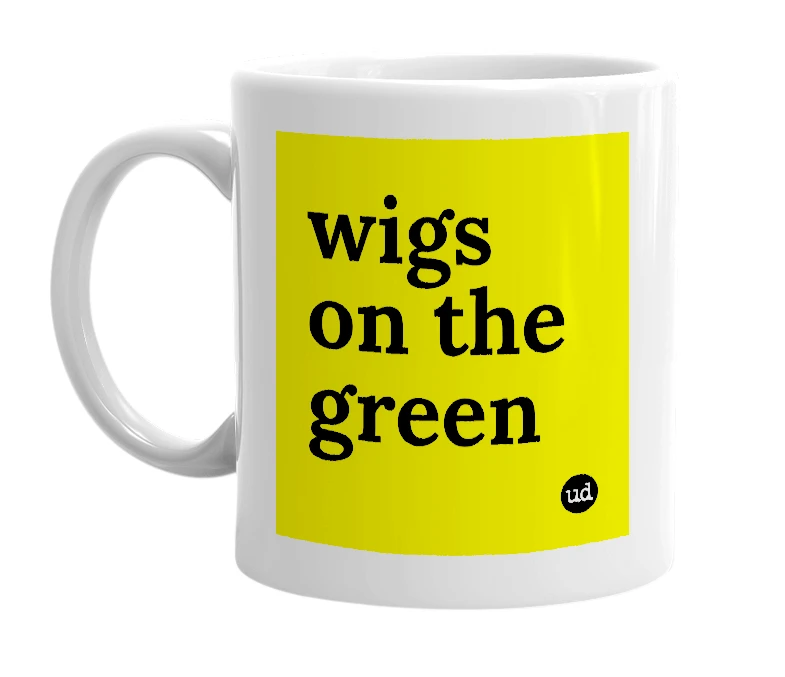 White mug with 'wigs on the green' in bold black letters
