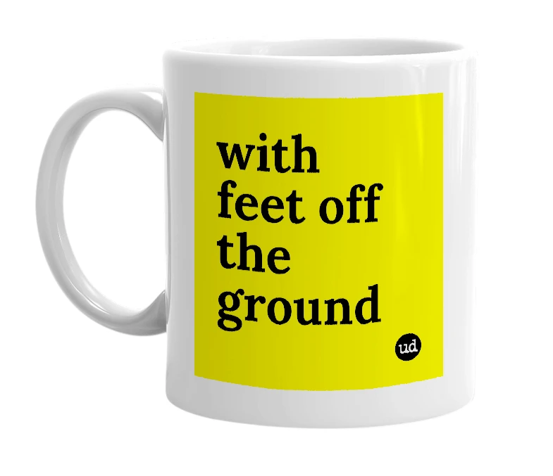 White mug with 'with feet off the ground' in bold black letters