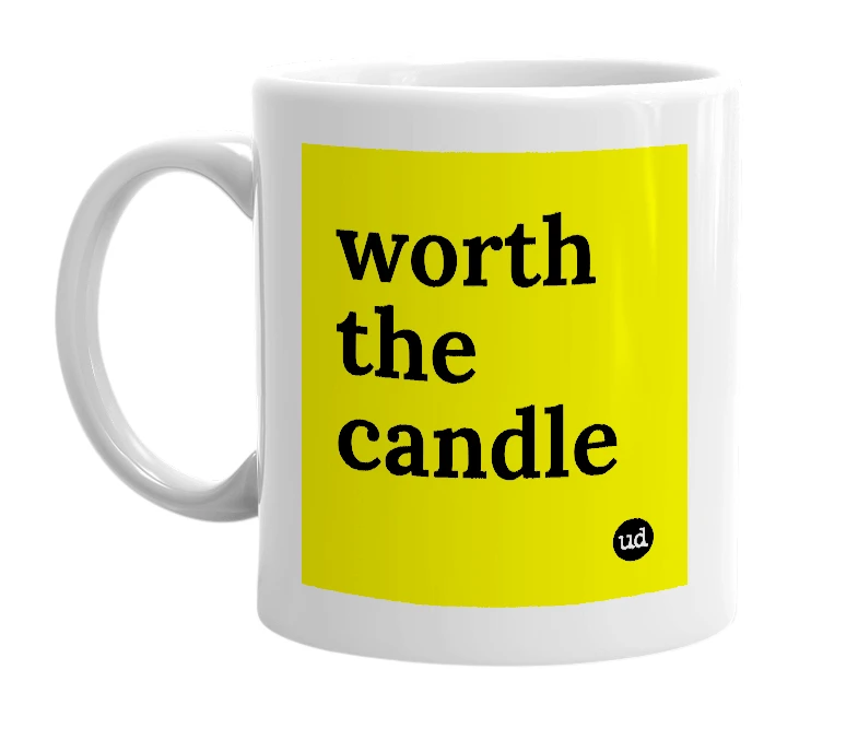 White mug with 'worth the candle' in bold black letters