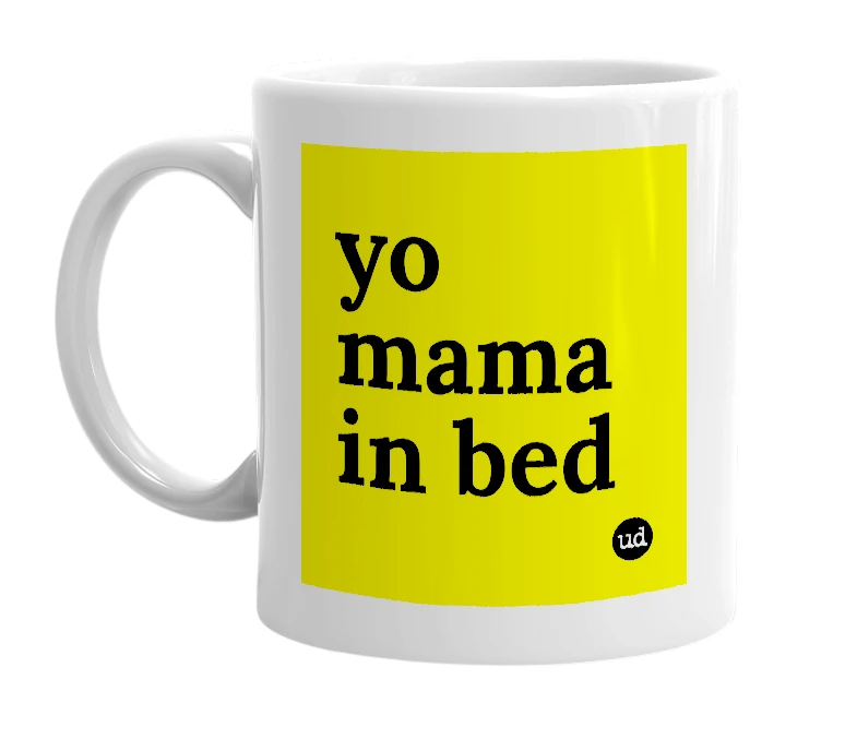 White mug with 'yo mama in bed' in bold black letters