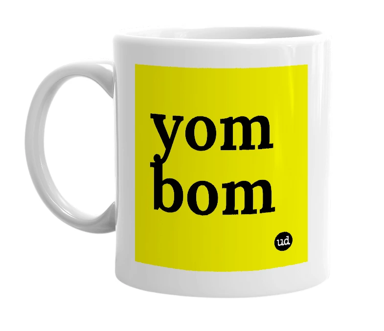 White mug with 'yom bom' in bold black letters