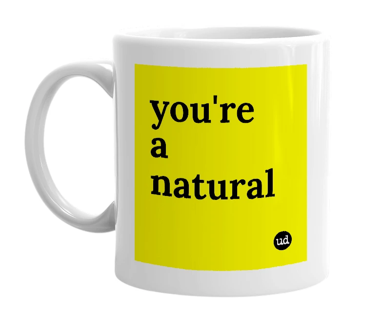 White mug with 'you're a natural' in bold black letters