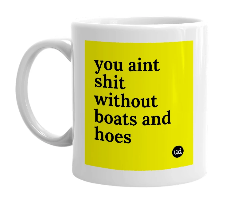 White mug with 'you aint shit without boats and hoes' in bold black letters