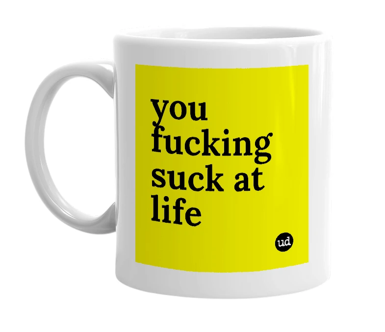 White mug with 'you fucking suck at life' in bold black letters